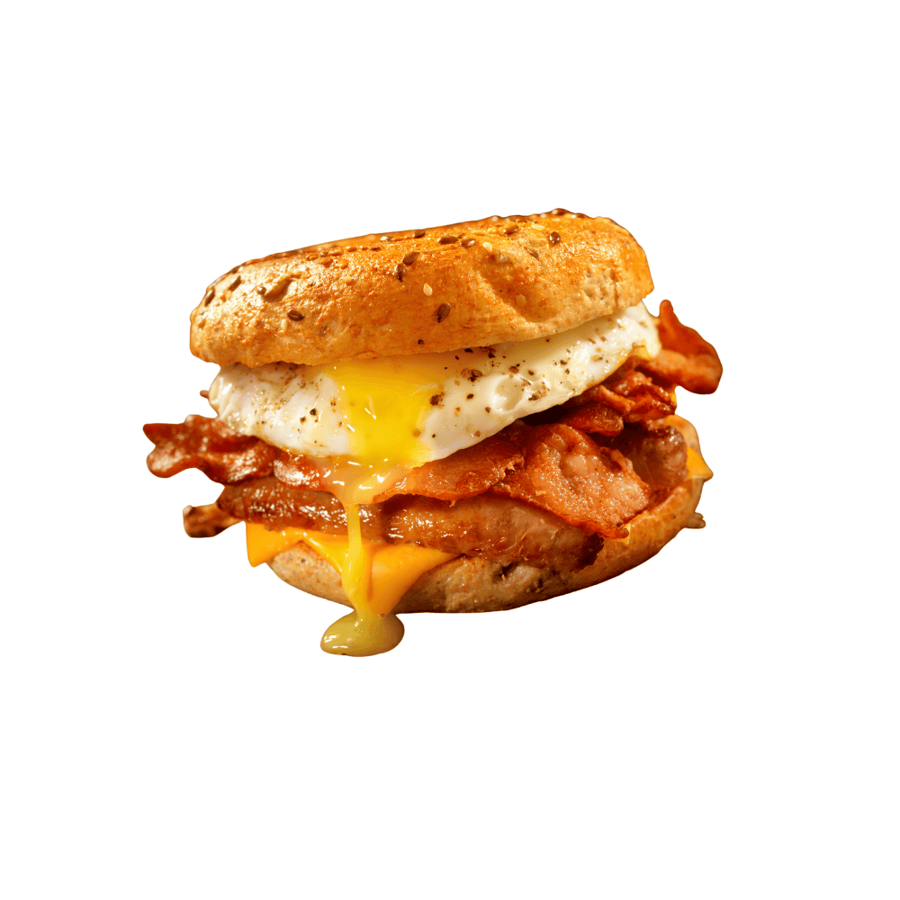 Egg and bacon breakfast sandwich with melted cheese on a bagel bun.