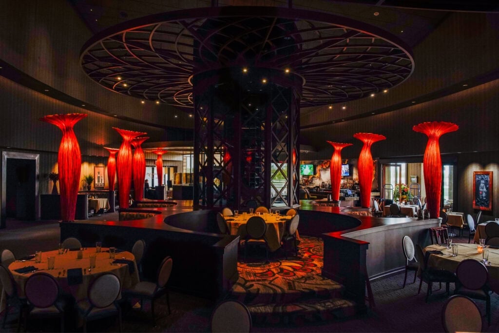 Odawa Casino & Resort interior featuring elegant dining area and distinctive red lighting sculptures.