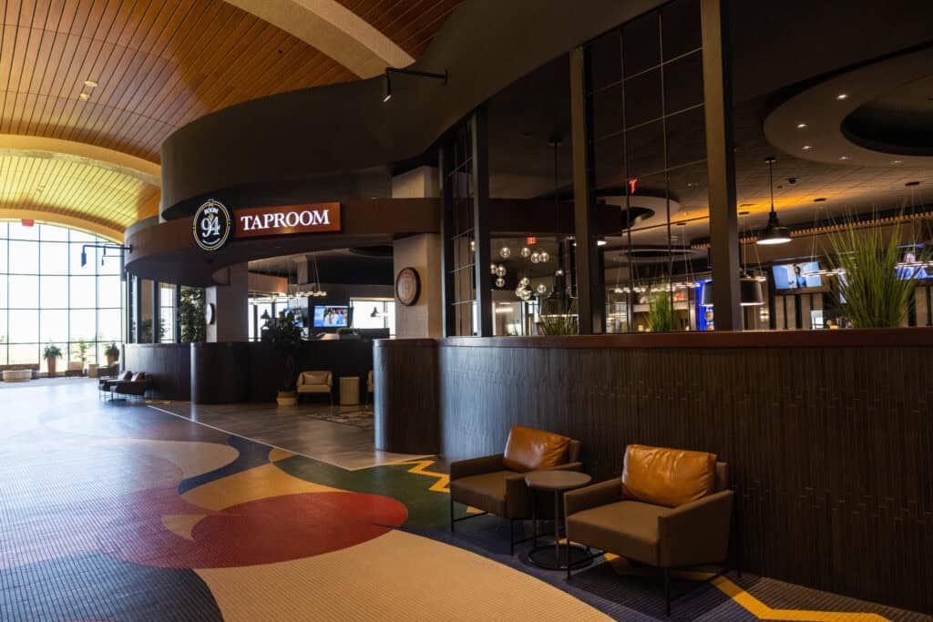 Elegant Odawa Casino & Resort lobby with taproom and lounge area showcasing gaming entertainment.