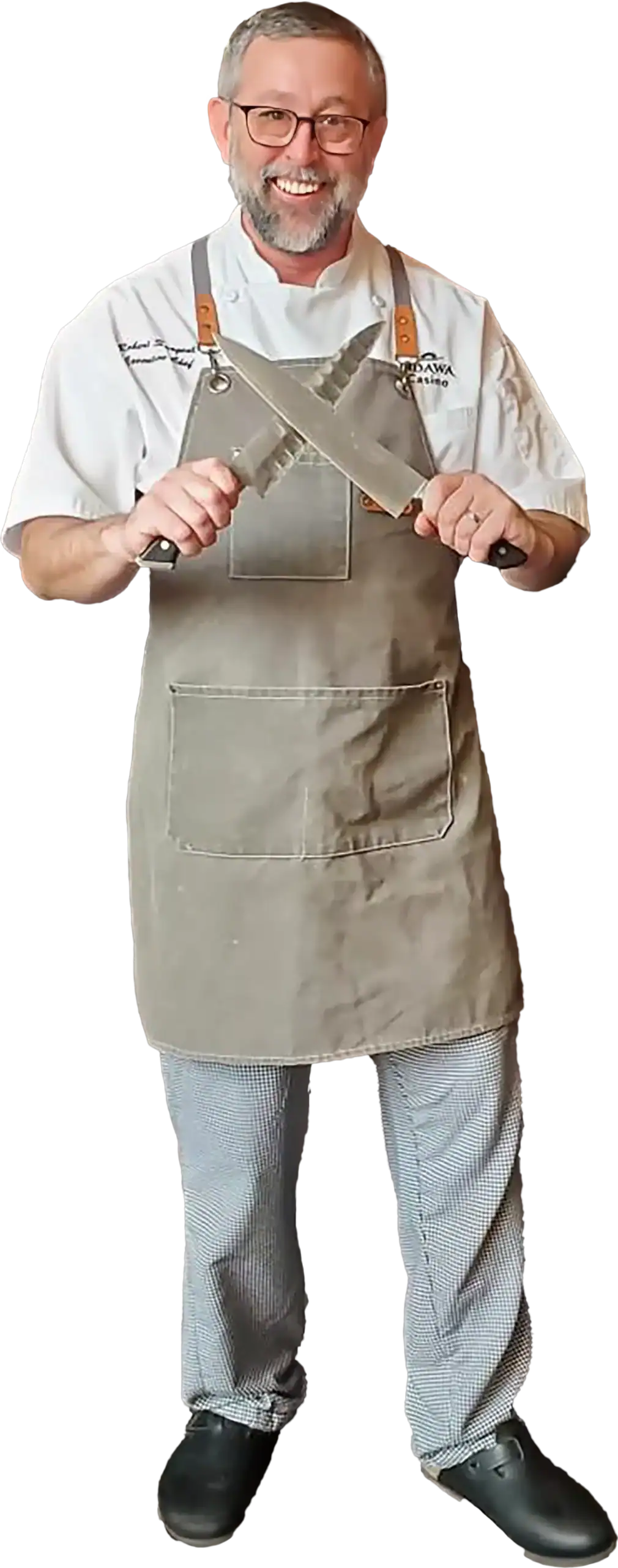 Chef holding a large knife, smiling, at Odawa Casino & Resort.