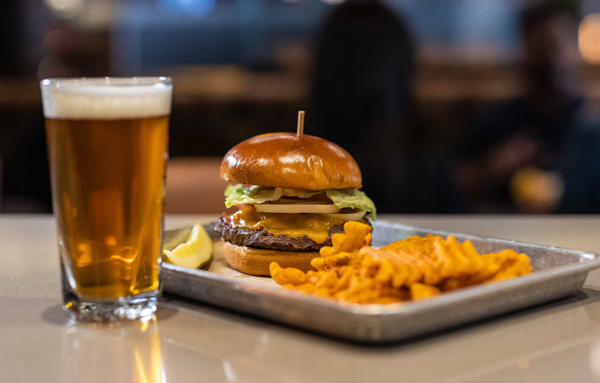 Juicy cheeseburger with fresh toppings and crispy fries at Odawa Casino & Resort.