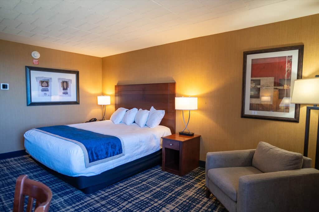 Modern hotel room at Odawa Casino & Resort with comfortable bedding and stylish decor.