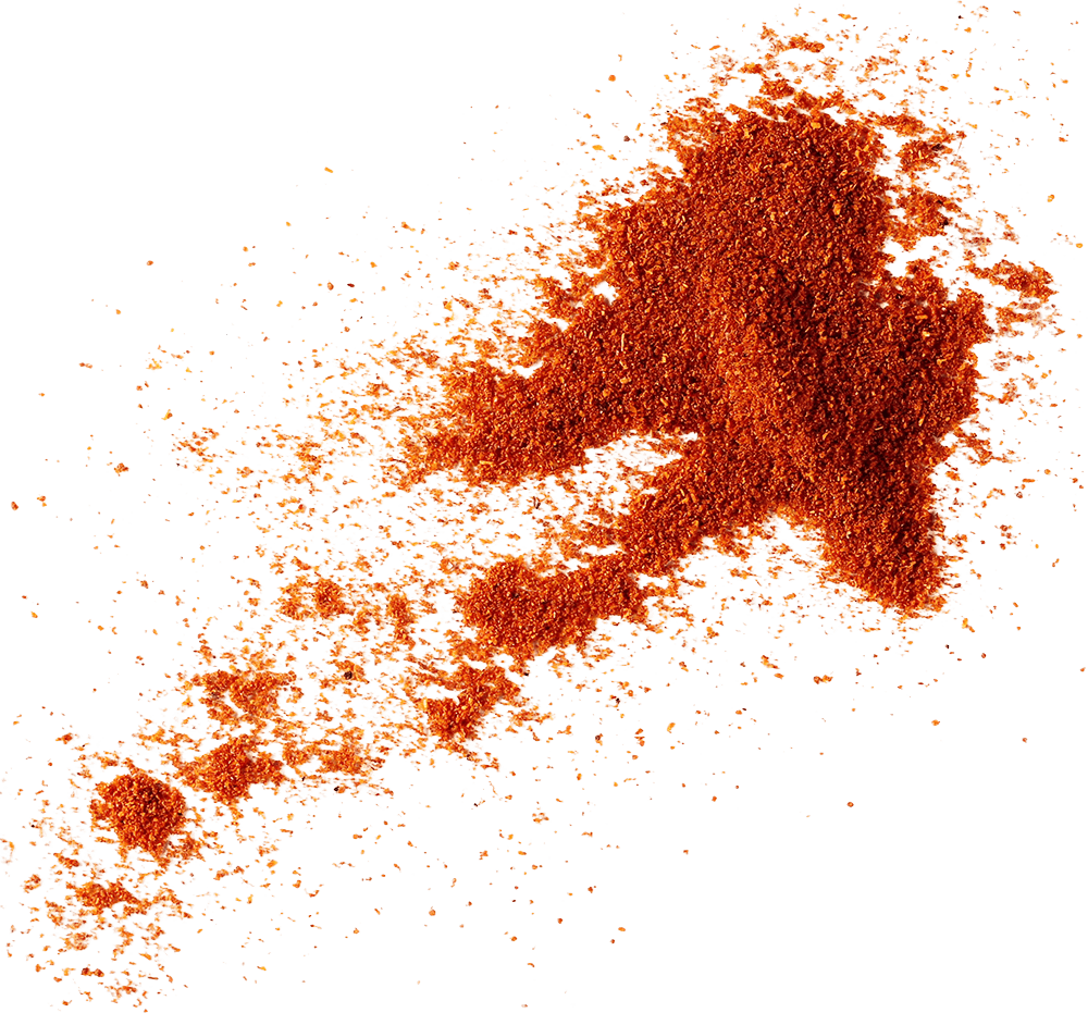 Spicy red chili powder spilled, with a smoky and vibrant color.