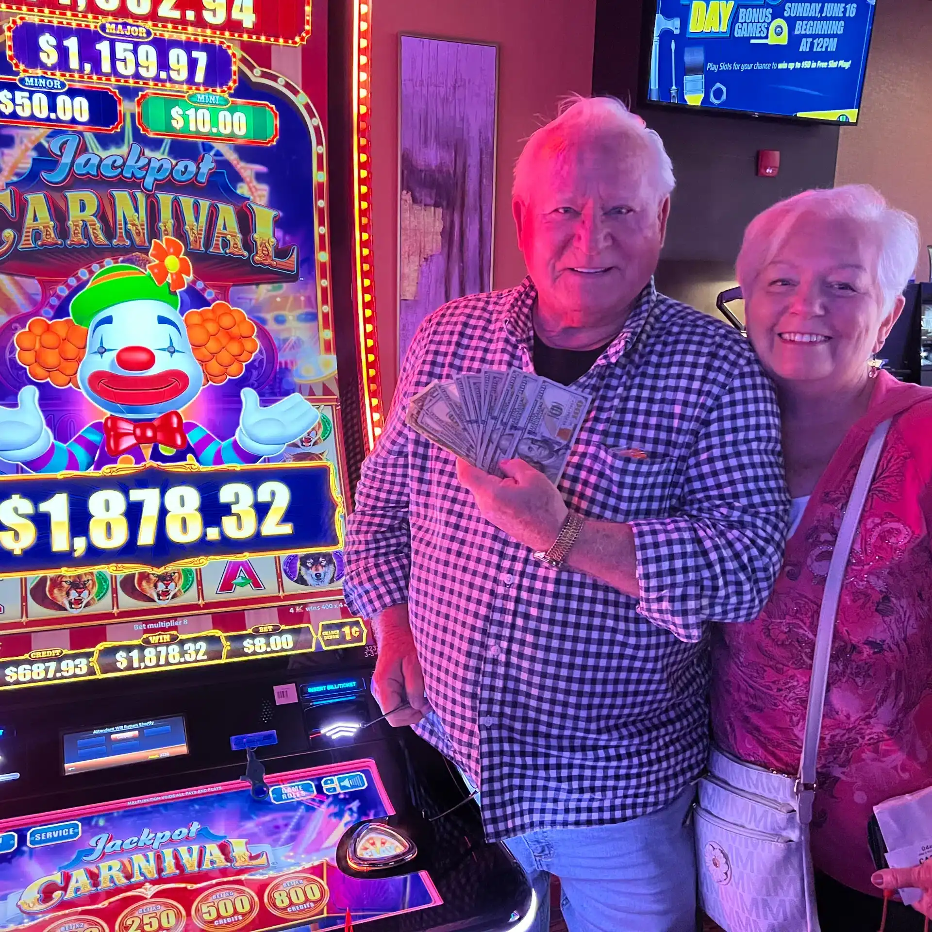 Winners at Odawa Casino & Resort playing slot machines, holding cash, celebrating casino wins.