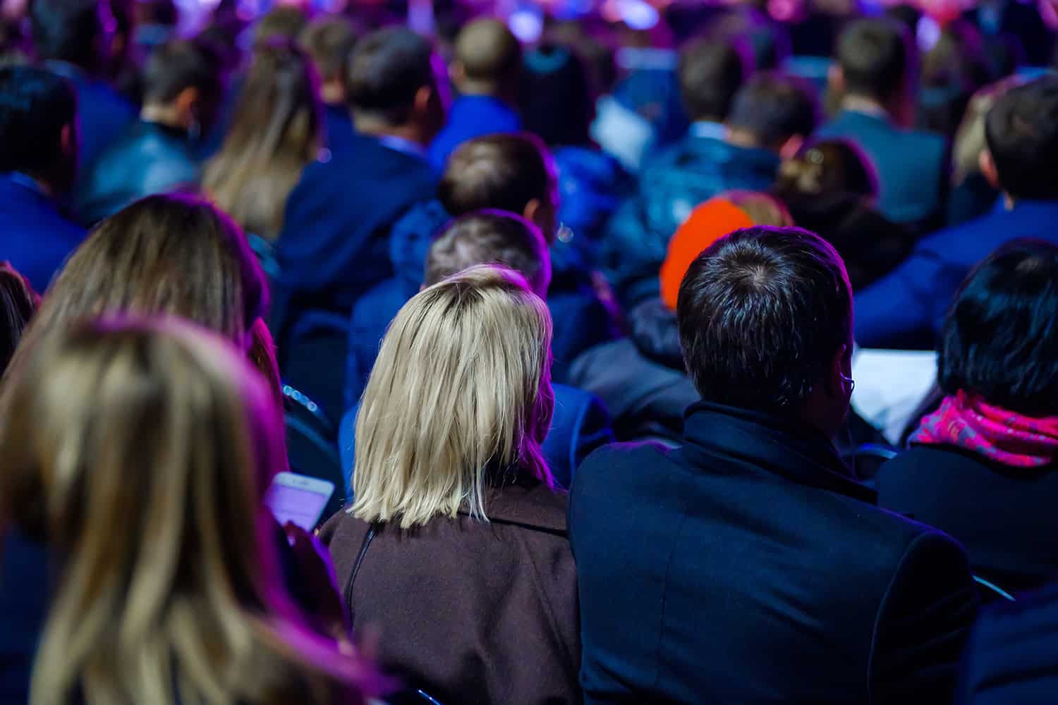 People attending Odawa Casino & Resort event under colorful lights.