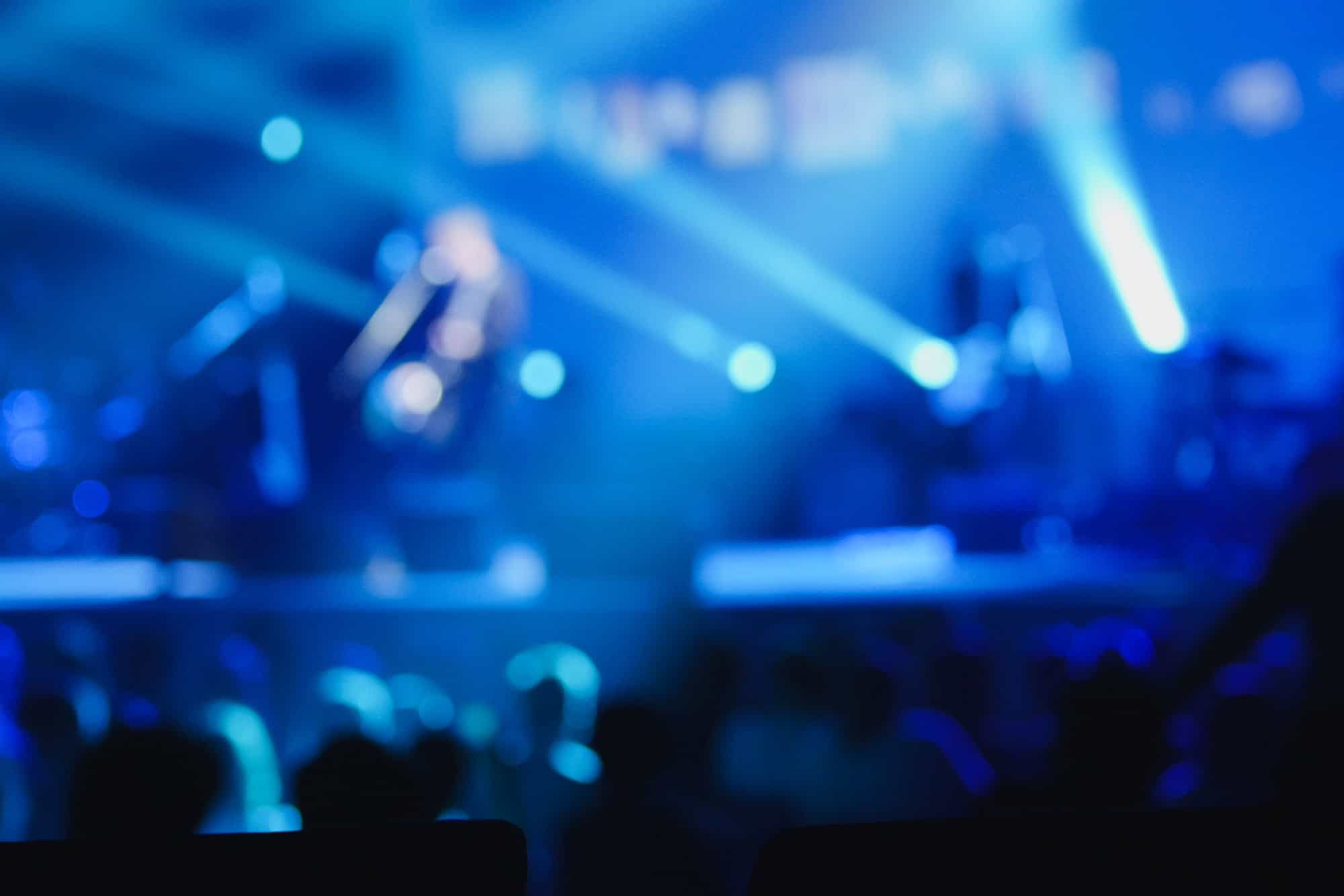 A vibrant blue-lit stage with dynamic lighting effects at Odawa Casino & Resort.