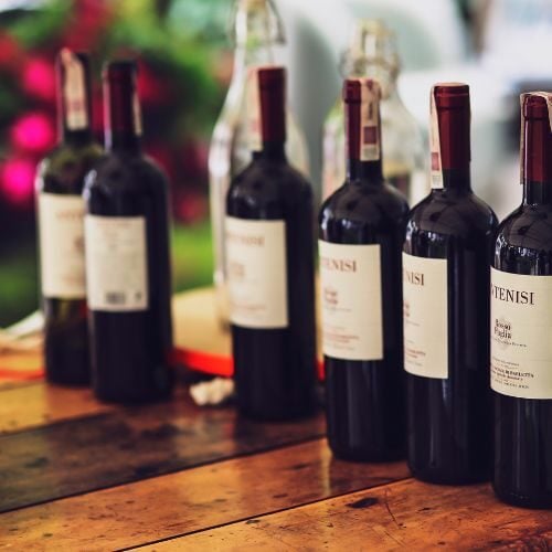 Elegant wine bottles displayed on a rustic wooden table at Odawa Casino & Resort, offering a luxurious dining and entertainment experience.