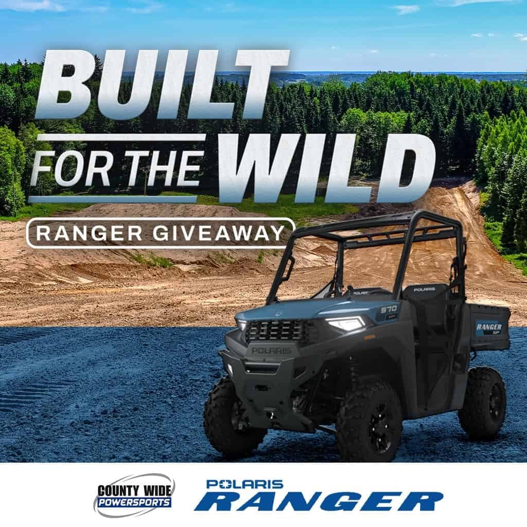 Polaris Ranger off-road vehicle in a forested outdoor setting.