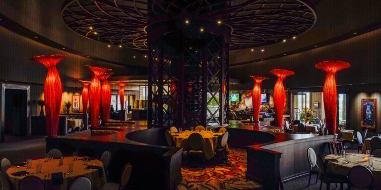 Odawa Casino & Resort interior featuring elegant dining area and distinctive red lighting sculptures.
