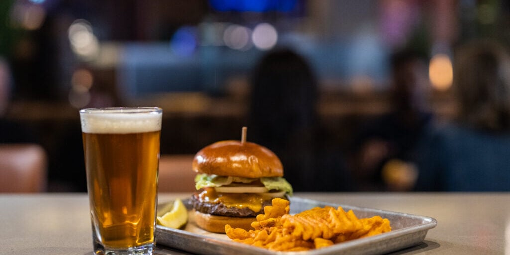 Delicious burger, crispy fries, and a cold beer at Odawa Casino & Resort restaurant.
