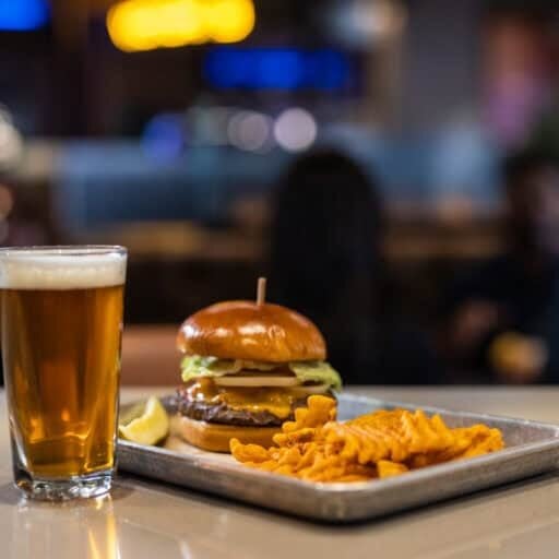 Delicious burger, crispy fries, and a cold beer at Odawa Casino & Resort restaurant.