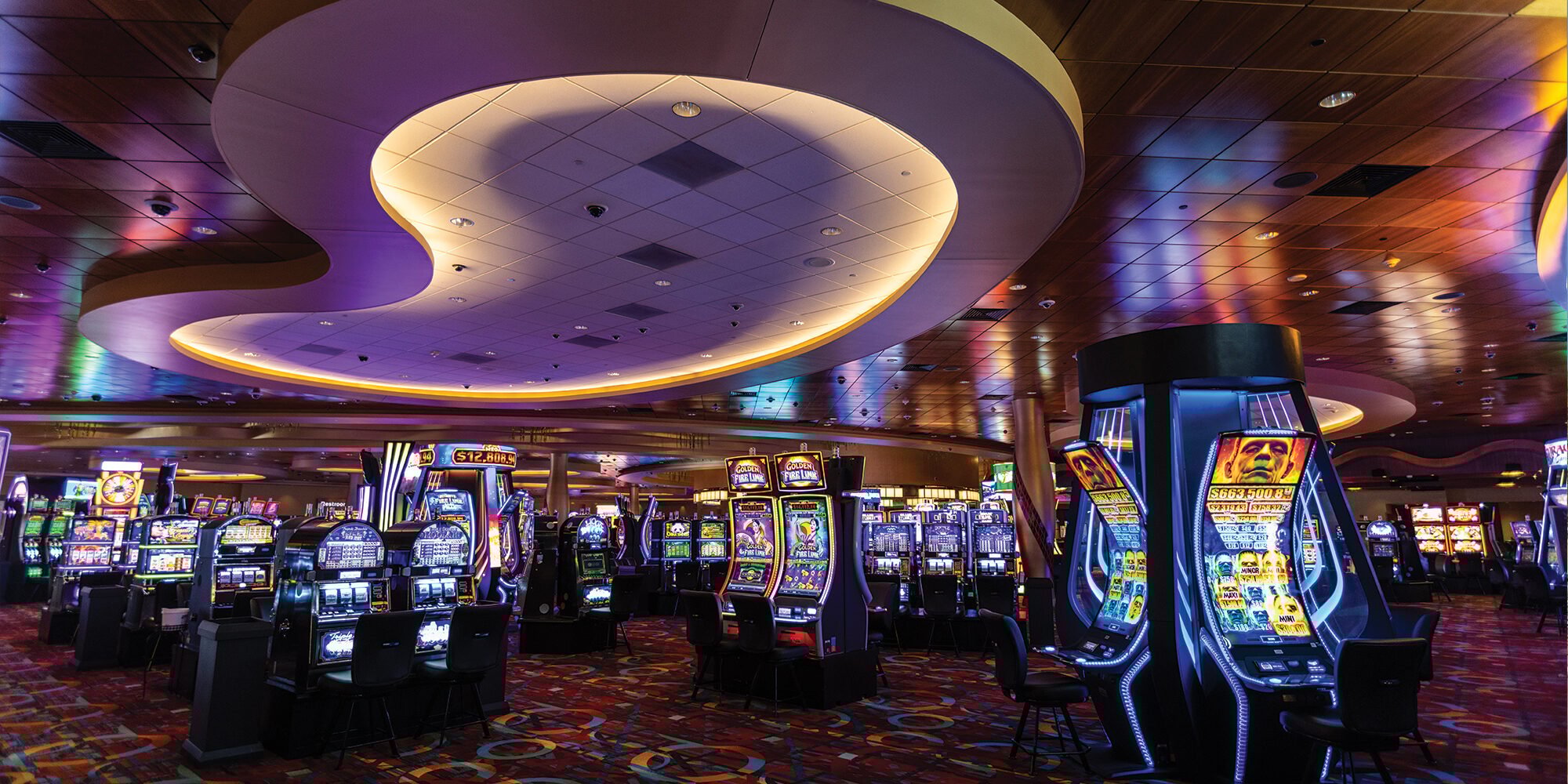 Vibrant casino floor at Odawa Casino & Resort with slot machines and colorful lighting.