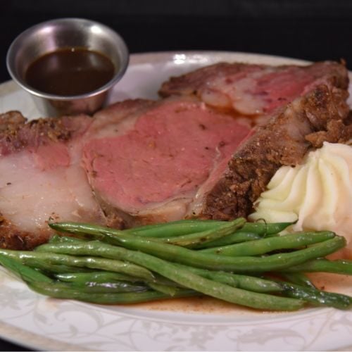 Juicy prime rib served with green beans, mashed potatoes, and au jus at Odawa Casino & Resort.