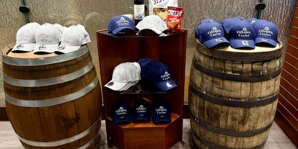 Odawa Casino & Resort branded hats on wooden barrels.