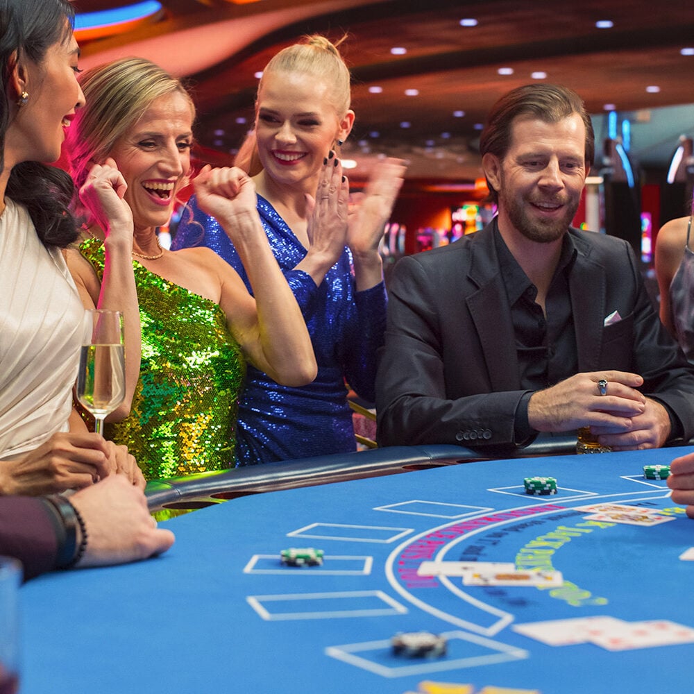 Friendly group enjoying gaming at Odawa Casino Resort, featuring lively atmosphere and casino table action.