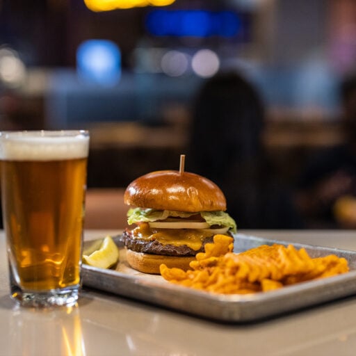Juicy cheeseburger with fries and a cold beer at Odawa Casino & Resort.