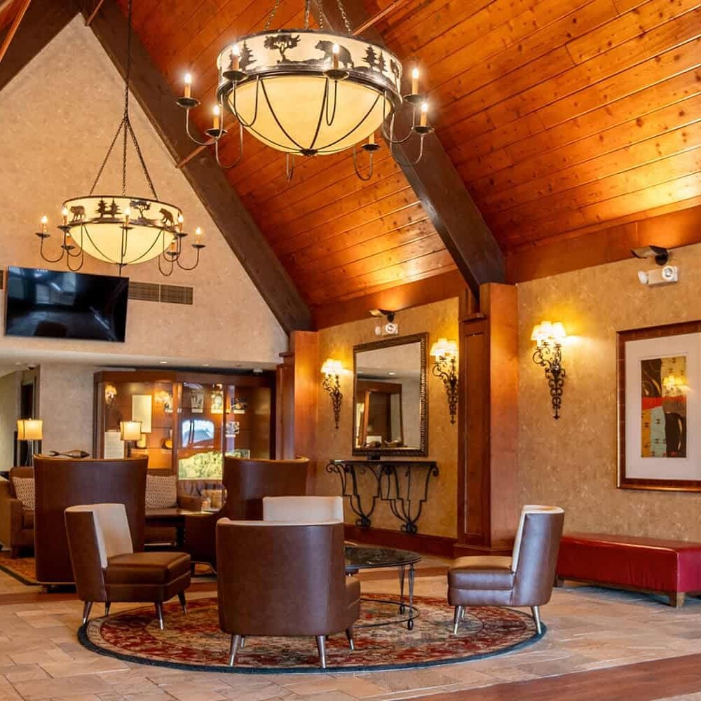 Cozy hotel lobby with wood-paneled ceiling, elegant lighting, and comfortable seating at Odawa Casino & Resort.