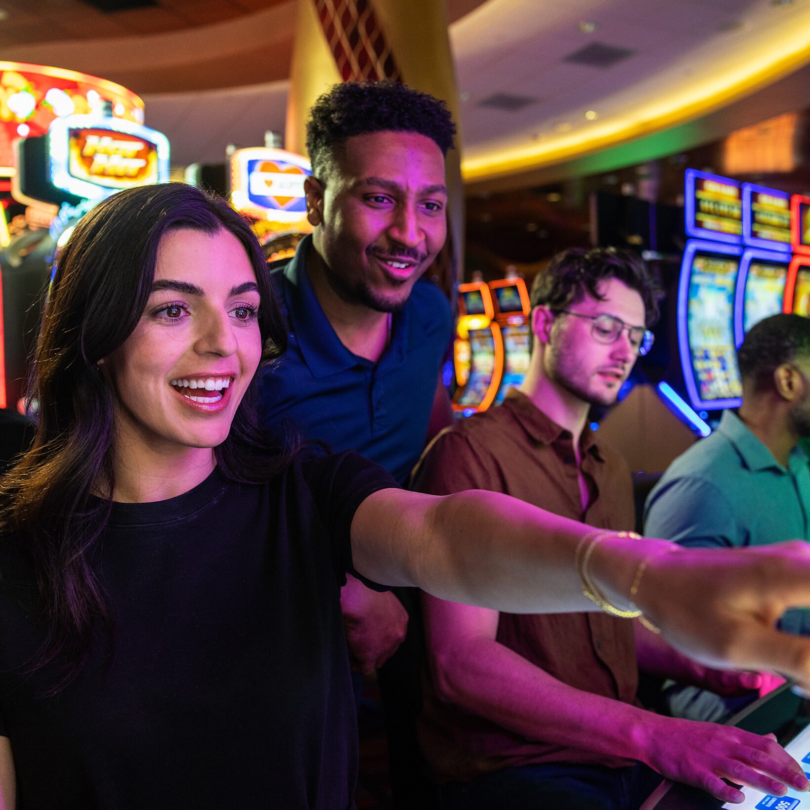 Brightly lit Odawa Casino & Resort with happy guests enjoying slot machines and gaming in a vibrant, lively environment.