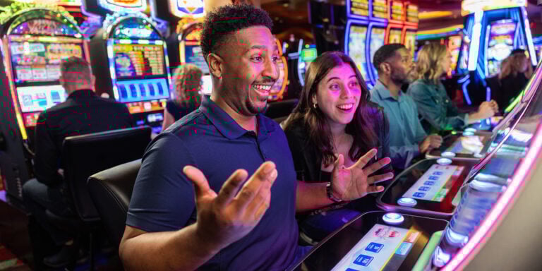 Excited people playing slot machines at Odawa Casino & Resort in Michigan.