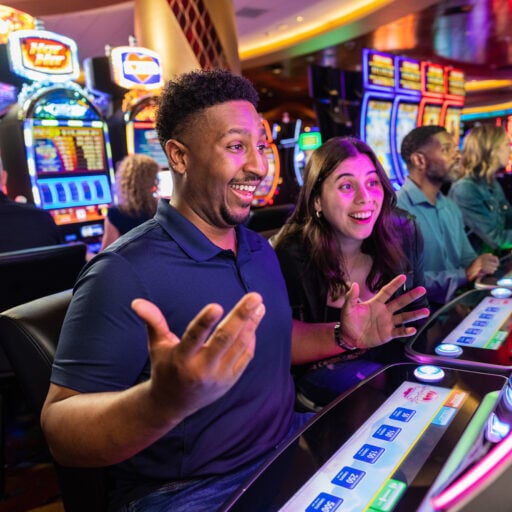 Excited people playing slot machines at Odawa Casino & Resort in Michigan.