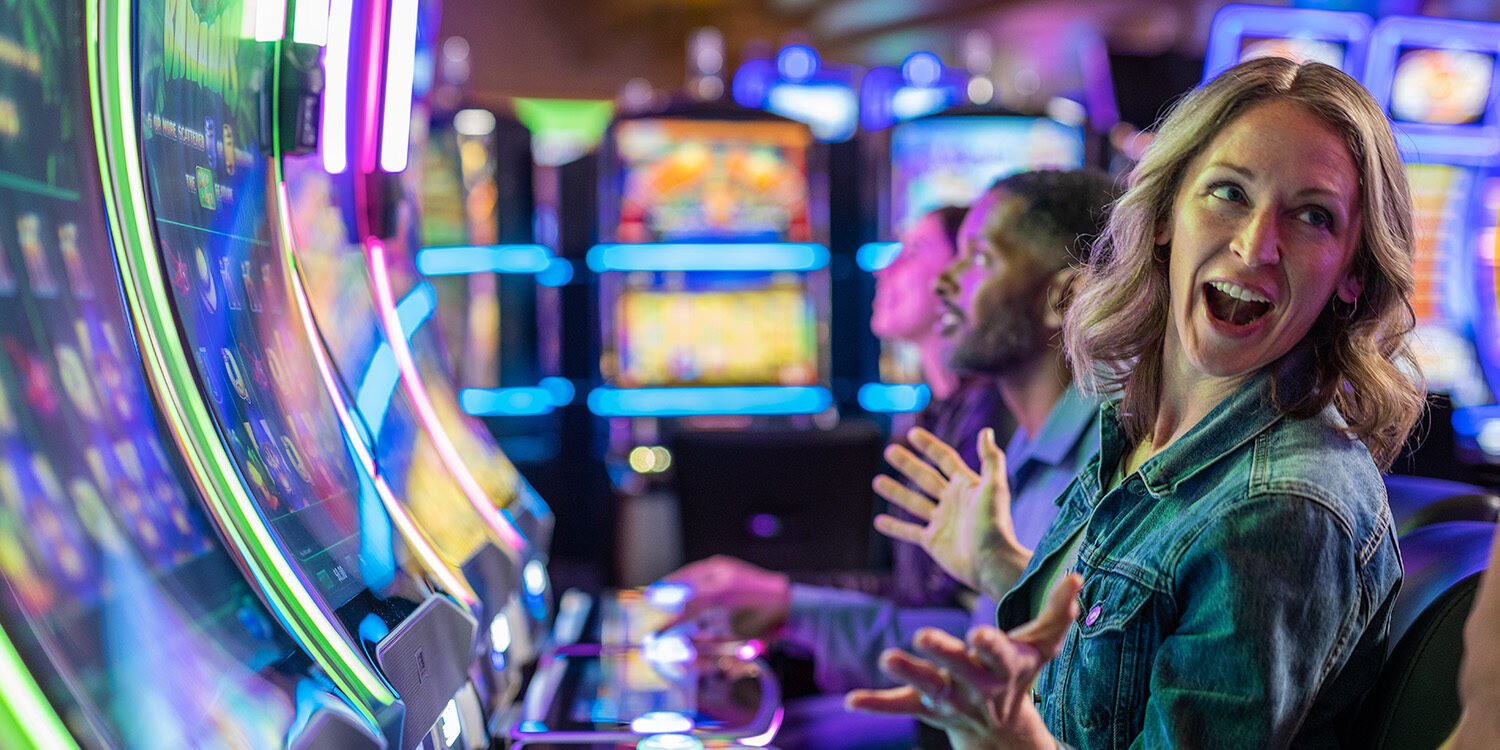 Bright casino slot machines at Odawa Casino & Resort with excited players enjoying gaming fun.