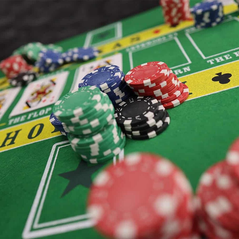 Colorful poker chips on green casino table at Odawa Casino & Resort.