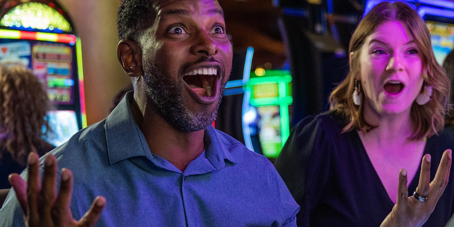 Excited people playing slot machines at Odawa Casino & Resort, offering thrilling gaming experiences.